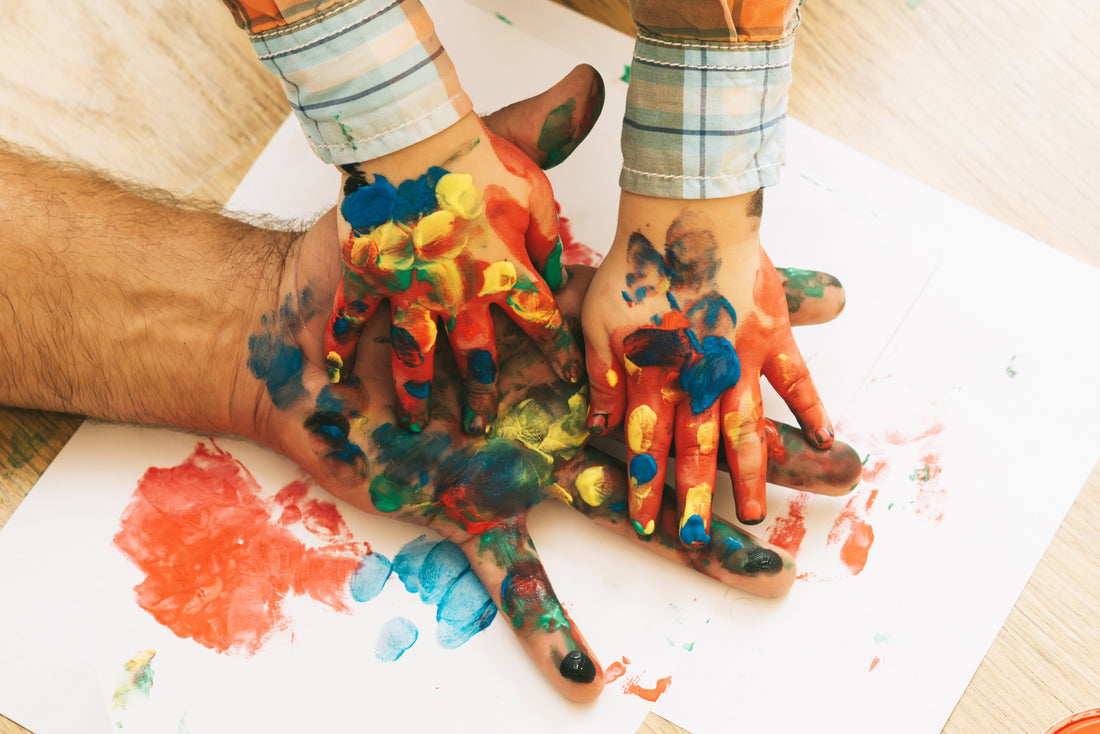 Colorful handprints on paper showing unique ways to document baby's first year through crafts